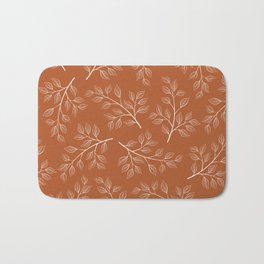Delicate White Leaves and Branch on a Rust Orange Background Badematte