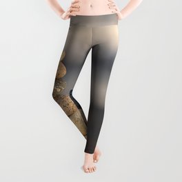 Pebbles stacked on the beach Leggings